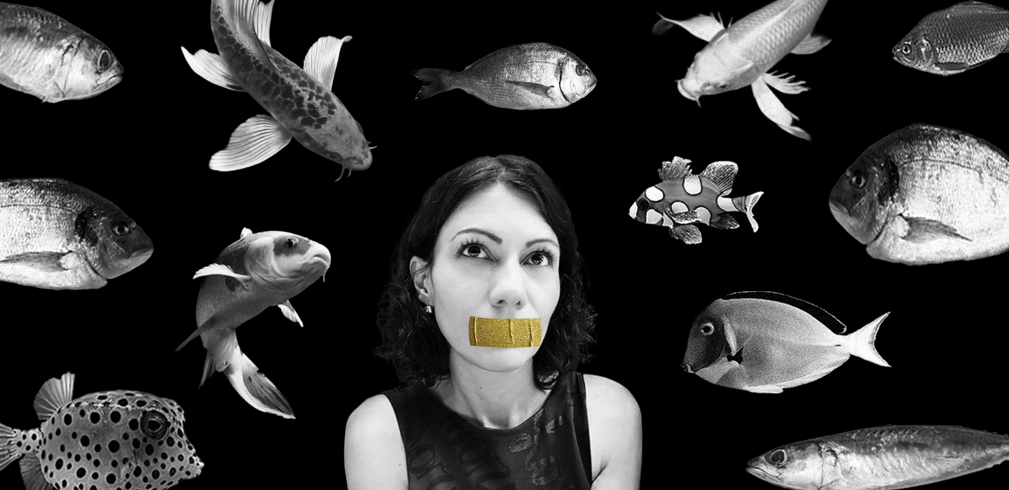 Alexandra Mark surrounded by fish, gold tape over mouth