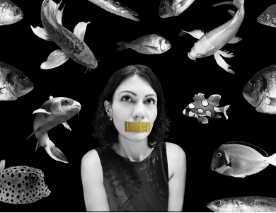 Alexandra Mark surrounded by fish, gold tape over mouth